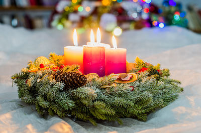 Close-up of illuminated candles on christmas decorations