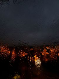 Close-up of wet illuminated during rainy season