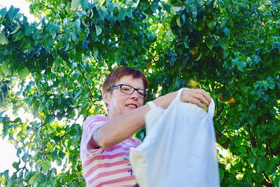 Portrait of smiling man standing against plants