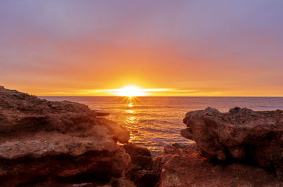 Scenic view of sea against sky during sunset