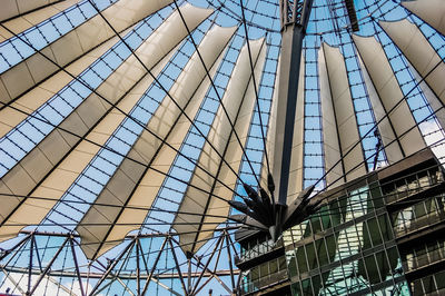 Low angle view of glass building against sky