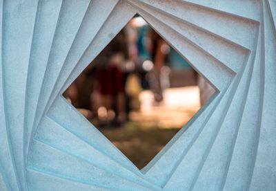 Close-up of couple kissing against curtain