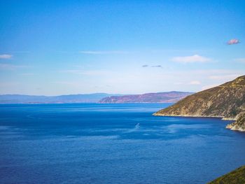 Scenic view of sea against blue sky