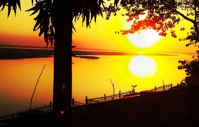 Scenic view of sea against orange sky