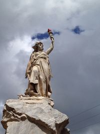 Low angle view of statue against cloudy sky