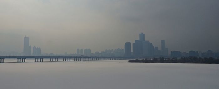 View of cityscape against sky during winter