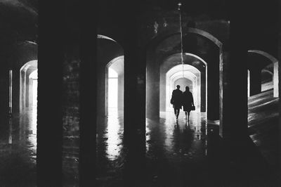 Rear view of man and woman standing in building