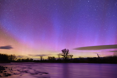 Scenic view of snow covered field against sky at night