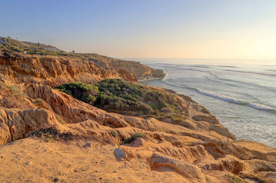 Scenic view of sea against clear sky during sunset