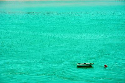 High angle view of boat moored in turquoise sea