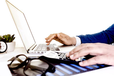 Midsection of man using mobile phone on table