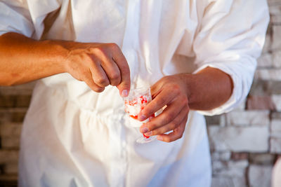 Midsection of man preparing food