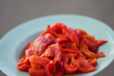 Close-up of red chili peppers in plate on table
