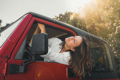 Side view of woman in car