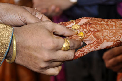 Midsection of couple holding hands