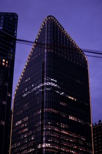 Low angle view of illuminated building against sky at dusk