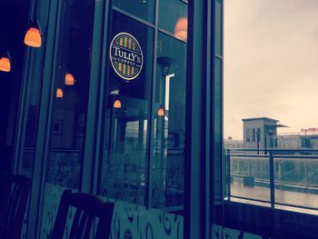 Reflection of building on glass window at night