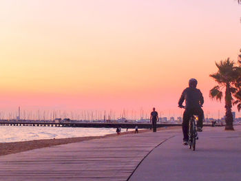 Silhouette of woman against clear sky at sunset