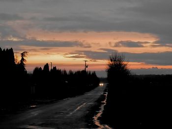 Silhouette trees against sky during sunset