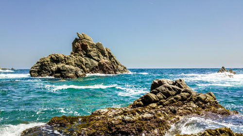 Scenic view of sea against clear blue sky