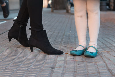 Low section of people walking on street