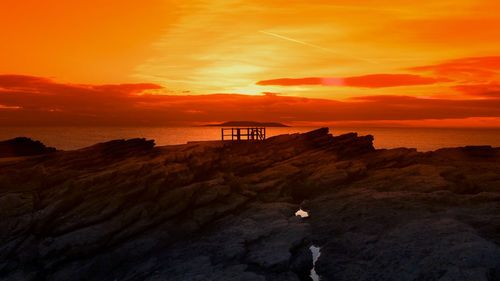 Seascape against cloudy sky at dusk