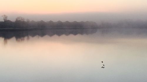 Scenic view of lake against sky during sunset