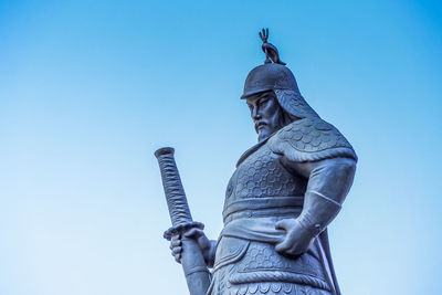 Low angle view of statue against clear blue sky