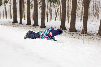 Full length of girl on snow covered field