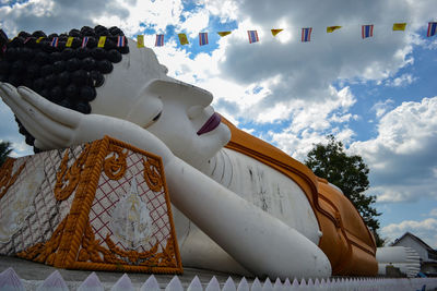 Low angle view of sculptures on building against sky