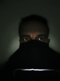 Portrait of man against black background