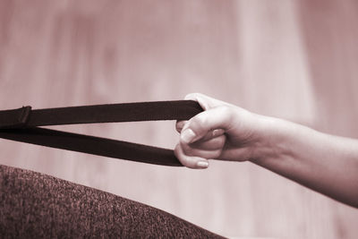 Close-up of woman holding equipment while exercising