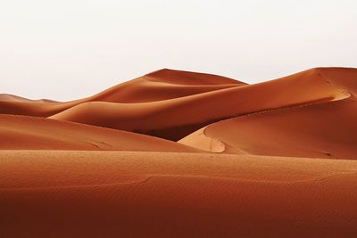 Sand dune in desert against clear sky