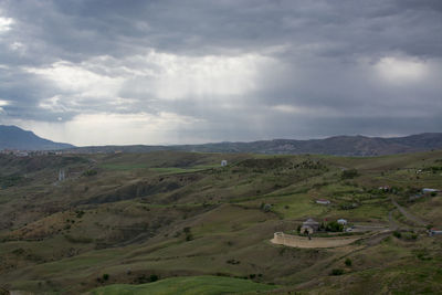 Scenic view of landscape against cloudy sky