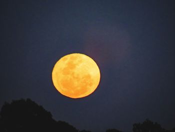 Low angle view of moon against clear sky at night