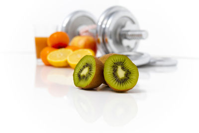 Close-up of fruits on table against white background