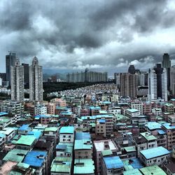 Cityscape against cloudy sky