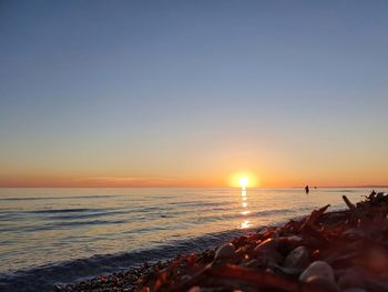 Scenic view of sea against clear sky during sunset