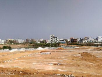 Buildings in city against clear sky