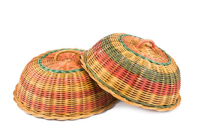 Close-up of wicker lids on white background