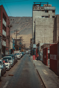 Street amidst buildings in city against sky