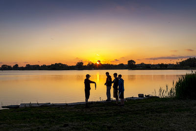 Silhouette of woman in water at sunset