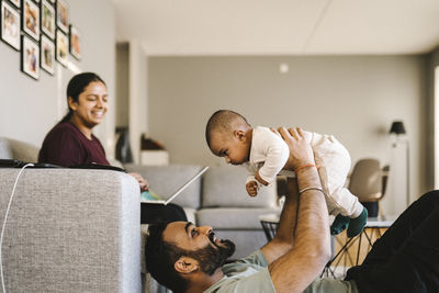 Father and mother with baby in living room