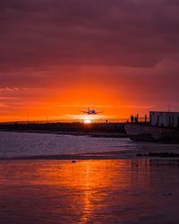 Scenic view of sea against orange sky