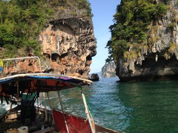 Panoramic view of rock formations in sea against sky