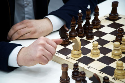 Midsection of man playing chess