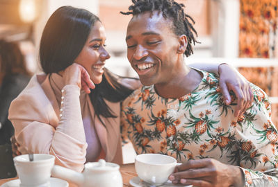 Cheerful couple sitting in cafe