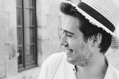 Close-up of smiling young man looking away