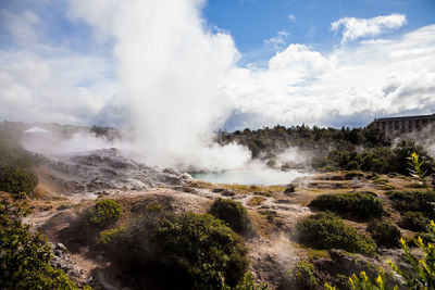 Scenic view of hot spring against sky