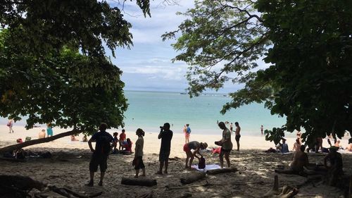 Group of people sitting on beach